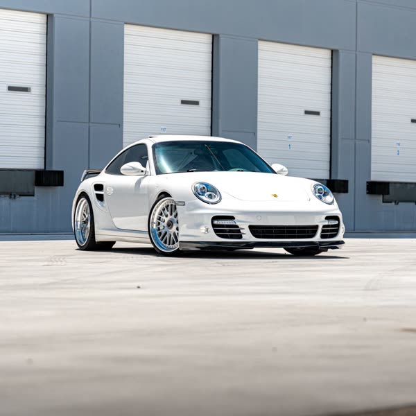 White Porsche 911 on a one-off set of MV Forged wheels outside the shop