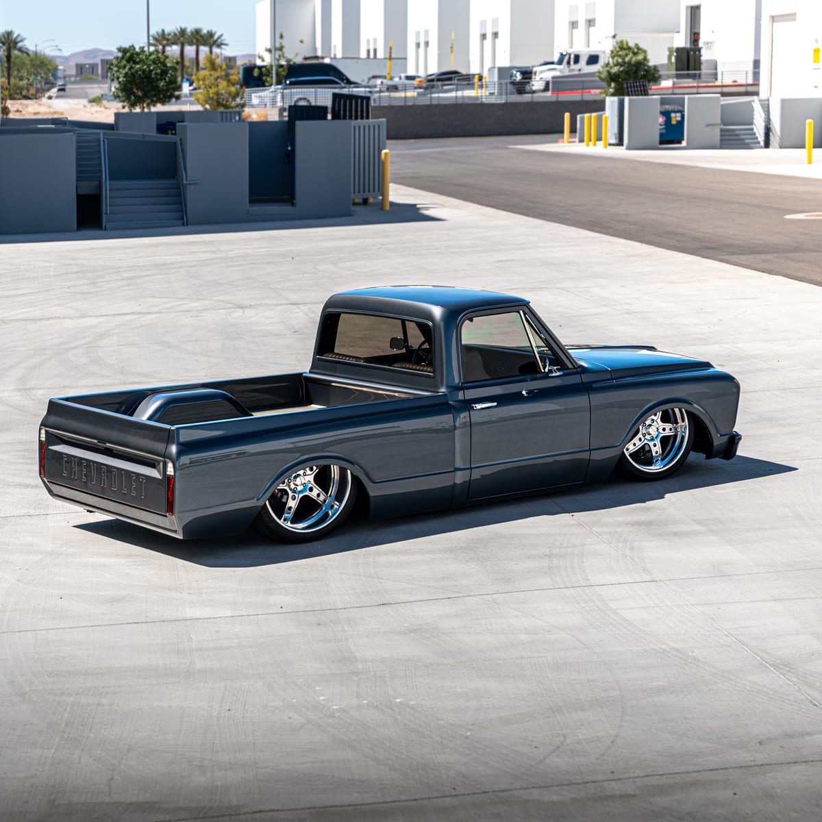 Restored Chevrolet C10 pickup laid out on polished five-spoke wheels
