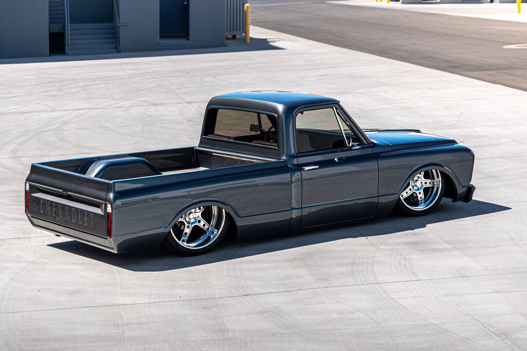 Restored Chevrolet C10 pickup laid out on polished five-spoke wheels
